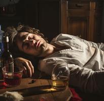 man-asleep-with-bottles-of-alcohol