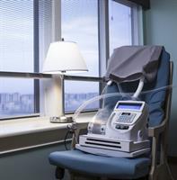 A CPAP machine with a mask on a nightstand